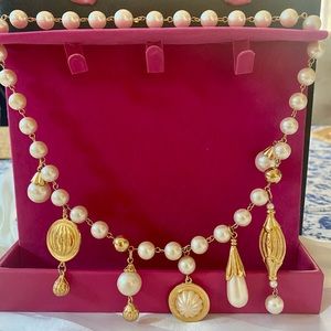 Pearl necklace with mixed gold plated metal and pearl charms.